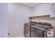 Laundry room equipped with stainless steel washer and dryer at 8021 Adelaide Hills St, Las Vegas, NV 89113