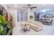Comfortable living room area with neutral furnishings, a dining table, and large windows for natural light at 8021 Adelaide Hills St, Las Vegas, NV 89113