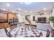 Bright and open living space with kitchen, dining area, and living room in view; lots of recessed lighting at 8021 Adelaide Hills St, Las Vegas, NV 89113