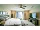 Digitally staged main bedroom with neutral colors, large window, and a comfortable bed at 8021 Adelaide Hills St, Las Vegas, NV 89113