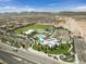 Aerial view of the community center, amenities, pools, and surrounding homes in a well-planned layout at 8405 Canyon Crevasse St, Las Vegas, NV 89166