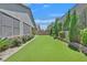 The backyard offers a well manicured lawn area, lush landscape, and a charming area for outdoor enjoyment at 8405 Canyon Crevasse St, Las Vegas, NV 89166