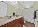 Bathroom with a double sink vanity, granite countertop and a toilet next to the shower at 8405 Canyon Crevasse St, Las Vegas, NV 89166