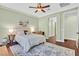 Bedroom with a ceiling fan, soft lighting, and an adjacent hallway at 8405 Canyon Crevasse St, Las Vegas, NV 89166