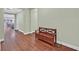 Spacious hallway featuring rich wood flooring and a stylish wooden storage bench at 8405 Canyon Crevasse St, Las Vegas, NV 89166