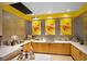 Bright juice bar kitchen area with modern countertops and stylish silver and yellow backsplash at 8405 Canyon Crevasse St, Las Vegas, NV 89166
