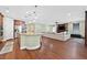 Open-concept living area featuring wood floors, a kitchen island and a cozy living room at 8405 Canyon Crevasse St, Las Vegas, NV 89166