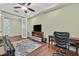 Well-lit home office with a desk, leather couch, and access to an additional room at 8405 Canyon Crevasse St, Las Vegas, NV 89166