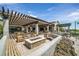 Outdoor patio with fireplace, seating, and pergola, perfect for dining and socializing in a relaxing atmosphere at 8405 Canyon Crevasse St, Las Vegas, NV 89166