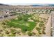 Aerial view of a community park with green space, walking trails, and mature trees at 8547 Benidorm Ave, Las Vegas, NV 89178