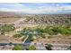 Aerial view of community park with lush landscaping, walking paths, playground, and a neighborhood pool at 8547 Benidorm Ave, Las Vegas, NV 89178