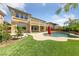 Expansive backyard showcasing a sparkling pool, lush artificial grass, and a beautiful home exterior at 8547 Benidorm Ave, Las Vegas, NV 89178