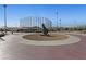 A baseball field area with covered dugouts and art installation on a sunny day for community sports at 8547 Benidorm Ave, Las Vegas, NV 89178
