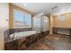 Bright primary bathroom with separate tub, glass block shower and vanity at 8547 Benidorm Ave, Las Vegas, NV 89178