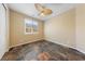 Bedroom featuring tile floors, a ceiling fan, and a window with natural light at 8547 Benidorm Ave, Las Vegas, NV 89178