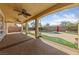 Expansive covered patio area featuring ceiling fans overlooking the backyard pool and lush landscaping at 8547 Benidorm Ave, Las Vegas, NV 89178