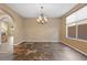 Dining room with tile floors, chandelier, and large window for natural light at 8547 Benidorm Ave, Las Vegas, NV 89178