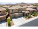 Two-story home with a three-car garage and desert landscaping at 8547 Benidorm Ave, Las Vegas, NV 89178