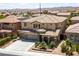 Two-story home with a three-car garage and desert landscaping at 8547 Benidorm Ave, Las Vegas, NV 89178
