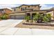 Charming two-story home featuring a three-car garage, stone accents, and a well-manicured front yard at 8547 Benidorm Ave, Las Vegas, NV 89178