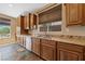 Well-lit kitchen with stainless steel appliances, beautiful granite countertops, and wooden cabinets at 8547 Benidorm Ave, Las Vegas, NV 89178