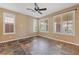 Bright living room featuring a ceiling fan, neutral colored walls, shuttered windows and tile flooring at 8547 Benidorm Ave, Las Vegas, NV 89178
