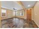Inviting living room featuring tile floors, neutral walls, ceiling fan and shuttered windows for natural light at 8547 Benidorm Ave, Las Vegas, NV 89178
