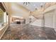 Open living room view to kitchen with tile floors and staircase leading to second floor at 8547 Benidorm Ave, Las Vegas, NV 89178