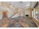 Large living room with fireplace and high ceilings, featuring tile flooring and staircase to the second floor at 8547 Benidorm Ave, Las Vegas, NV 89178