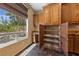 Walk-in pantry with pull-out shelves, granite countertop, and window views at 8547 Benidorm Ave, Las Vegas, NV 89178