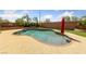 Inviting backyard pool area with lush greenery, complemented by a red umbrella for shaded lounging at 8547 Benidorm Ave, Las Vegas, NV 89178