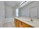 Well-lit bathroom with double sinks, a large mirror, and a shower-tub combination at 8675 Traveling Breeze Ave # 101, Las Vegas, NV 89178