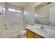 Standard bathroom with a shower-tub combo, tile flooring, and wooden vanity at 8675 Traveling Breeze Ave # 101, Las Vegas, NV 89178
