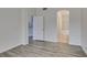 Spacious bedroom featuring laminate flooring and access to ensuite bathroom with shower-tub at 8675 Traveling Breeze Ave # 101, Las Vegas, NV 89178