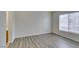 Bright bedroom with laminate floors, neutral walls, and a window with blinds at 8675 Traveling Breeze Ave # 101, Las Vegas, NV 89178
