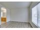 Spacious bedroom featuring laminate flooring and access to ensuite bathroom with wood vanity at 8675 Traveling Breeze Ave # 101, Las Vegas, NV 89178