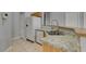 Clean kitchen with granite counters, stainless sink, and white appliances at 8675 Traveling Breeze Ave # 101, Las Vegas, NV 89178