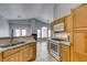 Open concept kitchen with granite countertops, white appliances, and view to living area at 8675 Traveling Breeze Ave # 101, Las Vegas, NV 89178