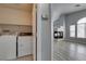 Laundry room with washer and dryer, adjacent to an open living space with fireplace at 8675 Traveling Breeze Ave # 101, Las Vegas, NV 89178