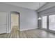 Open-concept living room with vaulted ceilings, a modern fireplace, and doors to the outside at 8675 Traveling Breeze Ave # 101, Las Vegas, NV 89178