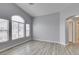 Bright living room with wood-look floors and natural light at 8675 Traveling Breeze Ave # 101, Las Vegas, NV 89178