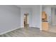 Living room with wood-look floors, view to kitchen and bathroom at 8675 Traveling Breeze Ave # 101, Las Vegas, NV 89178