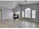 Open living room with new wood laminate flooring, a corner fireplace, and high ceilings at 8675 Traveling Breeze Ave # 101, Las Vegas, NV 89178