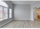 Bright living room with wood-look floors, natural light and archway to bathroom at 8675 Traveling Breeze Ave # 101, Las Vegas, NV 89178