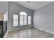 Living room with fireplace, wood-look floors and natural light from windows at 8675 Traveling Breeze Ave # 101, Las Vegas, NV 89178