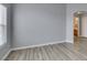 Bright living room with wood-look floors and view to bathroom at 8675 Traveling Breeze Ave # 101, Las Vegas, NV 89178