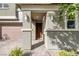 Inviting front entryway with stone pillars and manicured landscaping, leading to a warm and welcoming home at 888 Cherry Glen Pl, Las Vegas, NV 89138
