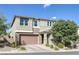 Inviting two-story home with a brick-paved driveway, complemented by desert landscaping, and a well-maintained facade at 888 Cherry Glen Pl, Las Vegas, NV 89138