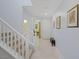 Bright and airy foyer featuring tile flooring, a staircase with white railing, and neutral wall paint at 888 Cherry Glen Pl, Las Vegas, NV 89138