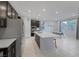 Modern kitchen featuring dark cabinetry, stainless steel appliances, and a large center island with seating at 888 Cherry Glen Pl, Las Vegas, NV 89138